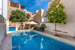 a swimming pool in the middle of a building at Casa Adriana con piscina in Murchas