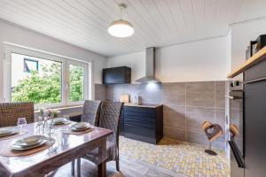 a kitchen and dining room with a table and chairs at Ferienhaus Soonwald Liebe in Seesbach