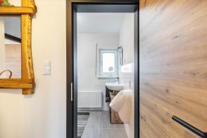 a bathroom with a toilet and a sink at Ferienhaus Soonwald Liebe in Seesbach +30 photos