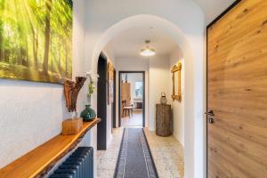 an arched hallway with a blue bench and a door at Ferienhaus Soonwald Liebe in Seesbach