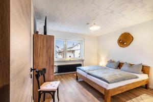 a bedroom with a bed and a window at Ferienhaus Soonwald Liebe in Seesbach