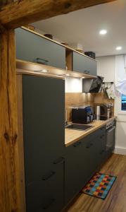 a kitchen with gray cabinets and a counter top at Schmidnickels Hof in Schwarzerden +22 photos