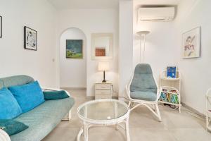 a living room with a couch and a table and chairs at Atalaya in Almuñécar