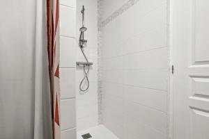 a shower with white subway tiles in a bathroom at Les Gîtes W elles come in Cotignac +16 photos