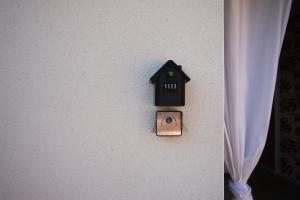 a lightswitch on a wall with a house on it at Les Gîtes W elles come in Cotignac