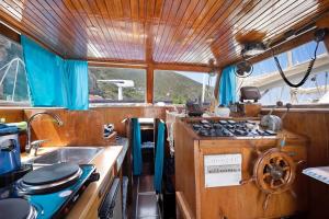 a kitchen with a stove and a sink in a boat at Aloha Jak's Boat in Alassio +34 photos