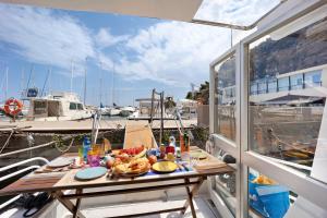 a plate of food on a table on a boat at Aloha Jak's Boat in Alassio