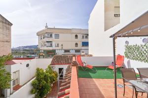 an apartment with a backyard with a playground at Estudio Quorum, centro de Nerja in Nerja