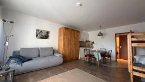 a living room with a couch and a table at Ferienwohnung Voges mit Pool in Bad Lauterberg