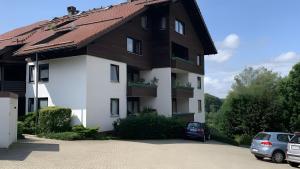a building with a car parked in front of it at Ferienwohnung Voges mit Pool in Bad Lauterberg