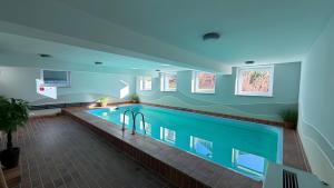 a large swimming pool in a building at Ferienwohnung Voges mit Pool in Bad Lauterberg