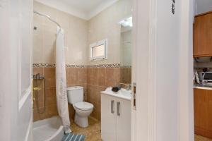 a bathroom with a toilet and a sink and a shower at Las Arenas Medio in La Mareta +18 photos