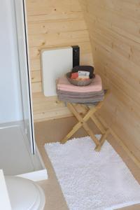 a tiny house with a table with a mirror and a rug at Barrel Papilles En Escapade in Sevremont