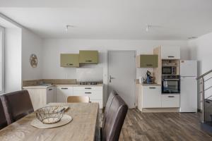 a kitchen and dining room with a table and chairs at Gîte Brain de nuit in Brain-sur-Allonnes +19 photos