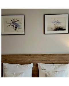 two framed pictures on the wall above a bed at VILLA LIPOVA STEGNA pokoje i apartamenty dedykowane osobom dorosłym in Stegna +45 photos