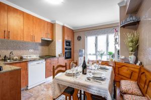 a kitchen with a table and chairs and a kitchen with a table and chairsktop at Rincón De Julia in Gijón