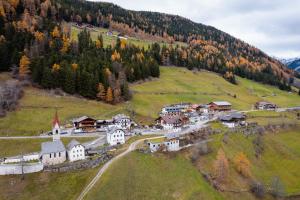 an aerial view of a small village on a hill at Huberhof Gais in Gais