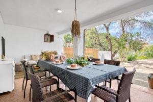 a dining room with a blue table and chairs at Araucaria in Denia