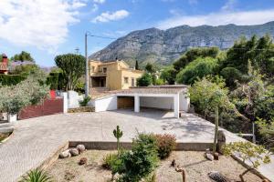 a house with a mountain in the background at Araucaria in Denia