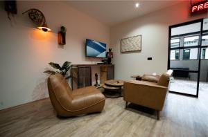 a living room with a couch and a chair at LV8 Chesterfield in Chesterfield