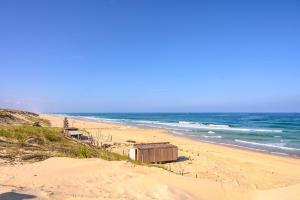 a beach with a building in the sand and the ocean at T2 Mimizan Plage in Mimizan-Plage