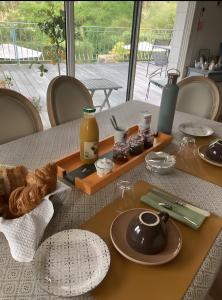 a table with plates of food on top of it at Chambre d'hotes La Rambleur in La Teste-de-Buch