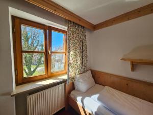 a small bedroom with a bed and a window at Hotel Rusticone Hechendorf in Seefeld +80 photos