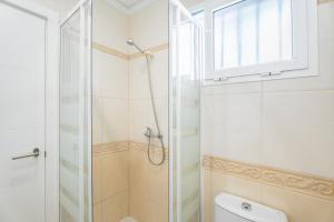 a bathroom with a shower and a toilet at Mont Pele in Cullera