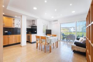 a kitchen and living room with a table and chairs at Mont Pele in Cullera +18 photos