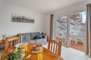 a living room with a table and a couch at Infinity Pool Views 2 Las Floritas in Playa de las Americas