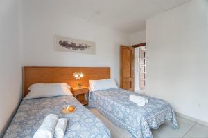 a bedroom with two beds and a table with a lamp at Infinity Pool Views 2 Las Floritas in Playa de las Americas