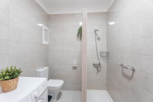 a white bathroom with a shower and a toilet at Infinity Pool Views 2 Las Floritas in Playa de las Americas