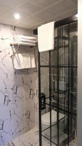 a bathroom with a glass shower stall and towels at Central Park Hotel İstanbul in Istanbul +44 photos