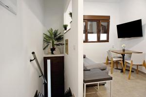 a living room with a table and a tv in it at Jardin Cardona in Arucas