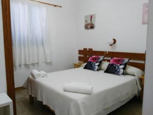 a bedroom with a bed with two towels on it at Casita in Illes Balears