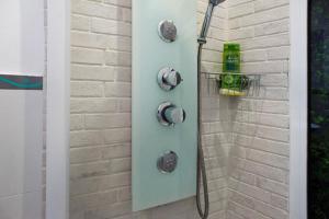 a shower with a green shower head in a bathroom at Jardin Cardona in Arucas +16 photos