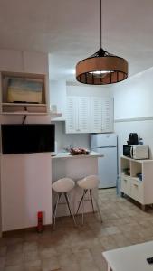 a kitchen with a counter and two stools in it at Casita in Illes Balears