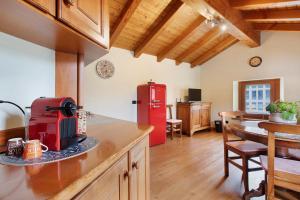 a kitchen with a red refrigerator and a table at La Mansardina - Aosta in Aosta