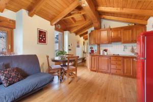 a kitchen with a couch and a table in a room at La Mansardina - Aosta in Aosta