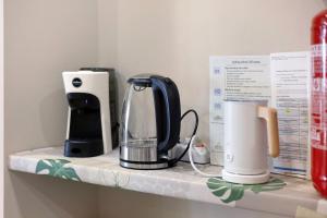 a counter with a coffee maker and a blender on it at B_B La Rugiada in Tigliole +27 photos