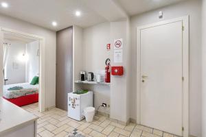 a room with a kitchen and a room with a bed at B_B La Rugiada in Tigliole