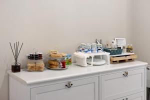 a white counter with pastries and other items on it at B_B La Rugiada in Tigliole