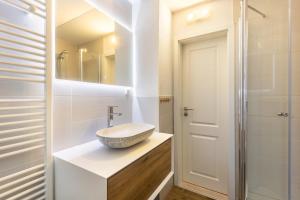 a bathroom with a sink and a mirror at Landhaus Sophie in Frielendorf +23 photos