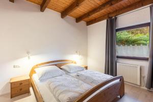 a bedroom with a bed in a room with a window at Landhaus Sophie in Frielendorf