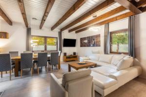 a living room with a couch and a table at Landhaus Sophie in Frielendorf
