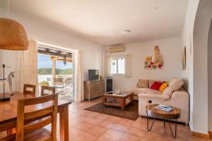 a living room with a couch and a table at Villa Torre Xanchu in Sant Josep de sa Talaia +14 photos