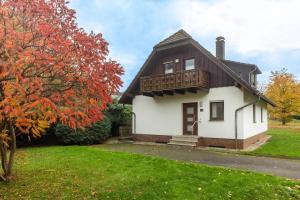 a house with a balcony on top of it at Landhaus Sophie in Frielendorf