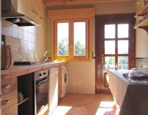 a kitchen with a sink and a stove at Vivir en el Campo in Cidones