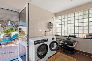 a washing machine in a room with a balcony at Archer'shouse - Olival's Treasure in Olival