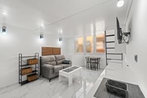 a living room with a couch and a table at Vima Lofts in Torrevieja